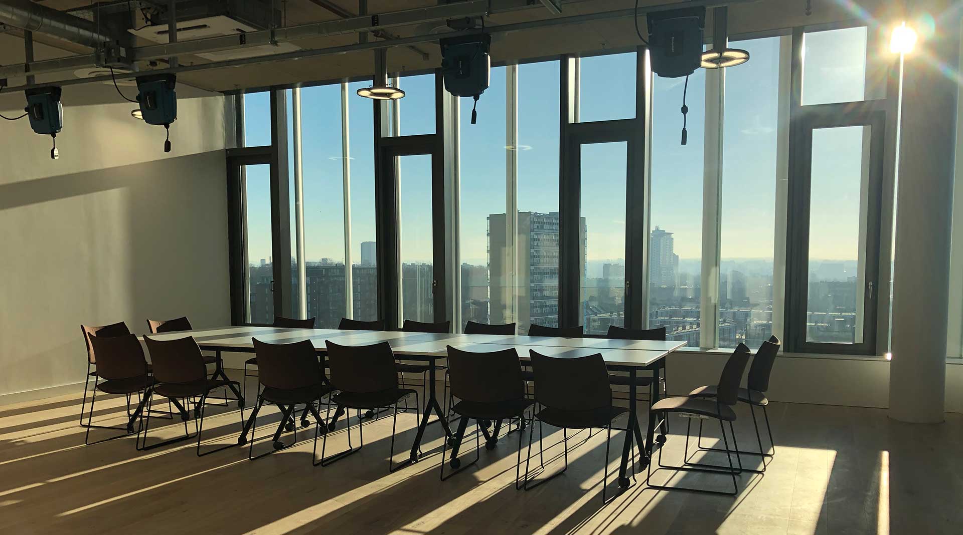 Meeting space at Royal Academy of Art fitted out by ISG, with a window view on sunny London landscape
