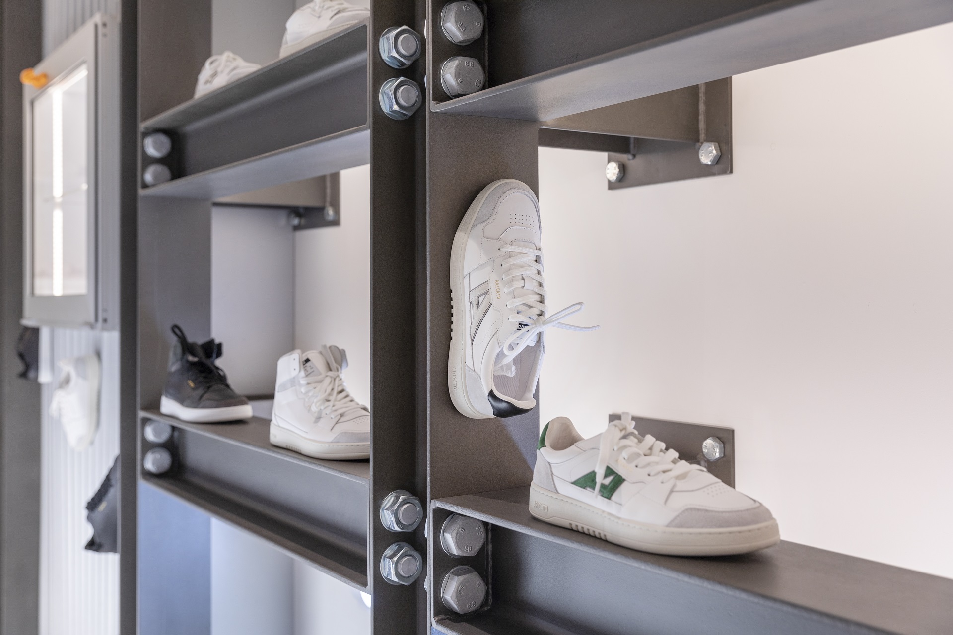 Photograph of a shop display with white trainers