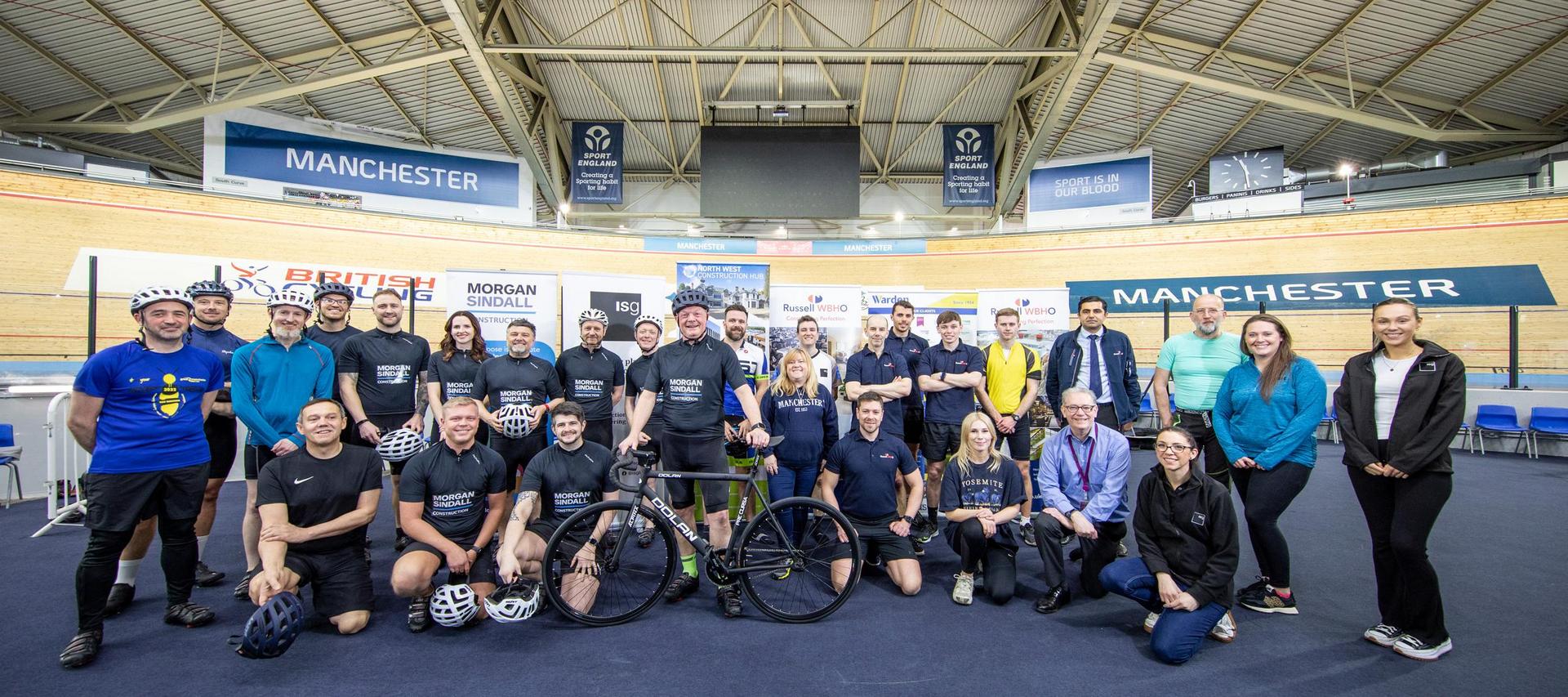 Group of people that took part in the charity cycle around the Manchester velodrome track
