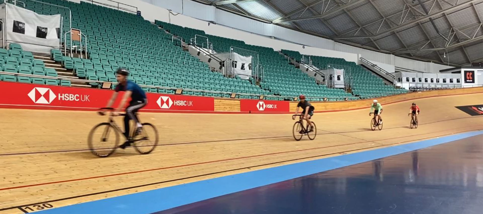 ISG team cycling on the Manchester velodrome track 