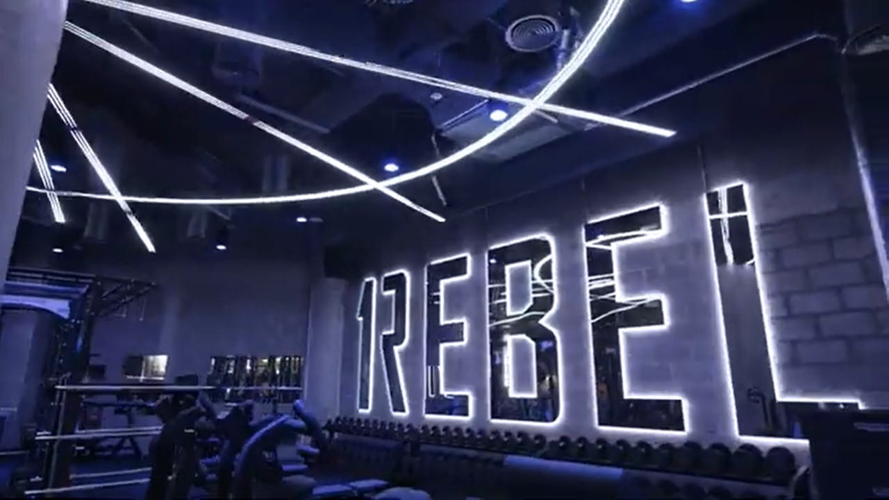Interior of !Rebel Gym with backlit logo on wall at ICD Brookfield Place, Dubai UAE
