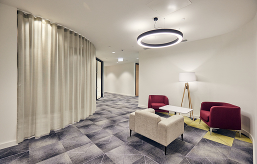 Waiting area with armchairs at corporate office fit out by ISG Ltd