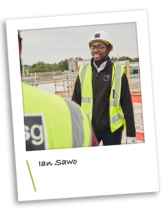 ISG early careers employee in PPE on a construction site smiling at the camera