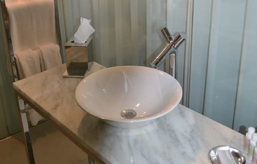 Interior photograph modern bathroom sink and table