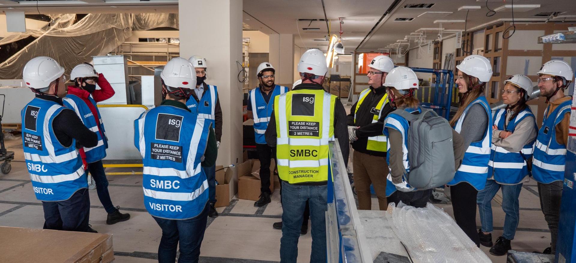 Group of people in PPE on an ISG construction site during Open Doors 2021