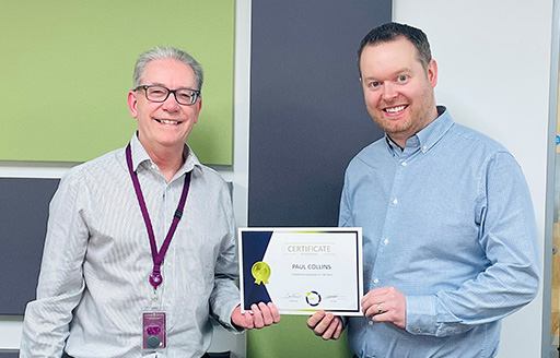 Ian Hall from NWCH awarding Paul Collins with Framework manager of the year