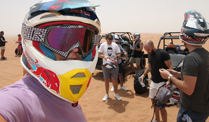 Andrew Collier ISG UAE wearing a motorcycle helmet in the desert