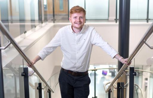 ISG graduate trainee Tom Hyett halfway up stairs