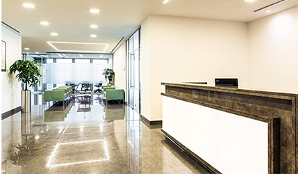 Modern white and grey reception are at a healthcare services laboratories project fit out by ISG Singapore