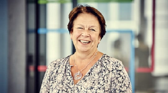 Headshot of ISG's Debbie Hobbs wearing a patterned top in an ISG office