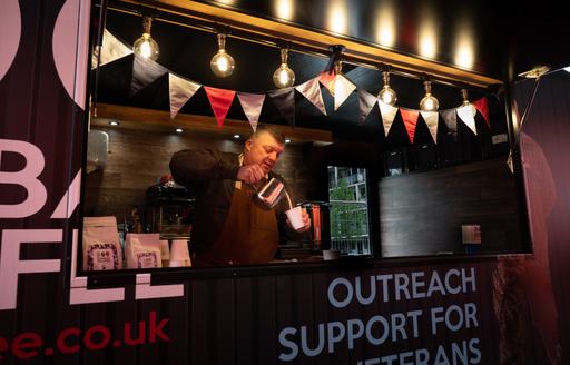 Nigel Seaman pouring coffee at Combat 2 Coffee Kiosk ISG