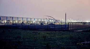 View of a manufacturing facility delivered by ISG from outer perimeter fences at night