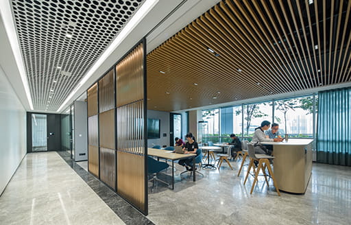 Employees working collaboratively in a cafe in the office fitted out by ISG for Chinese Tech Giant in Singapore