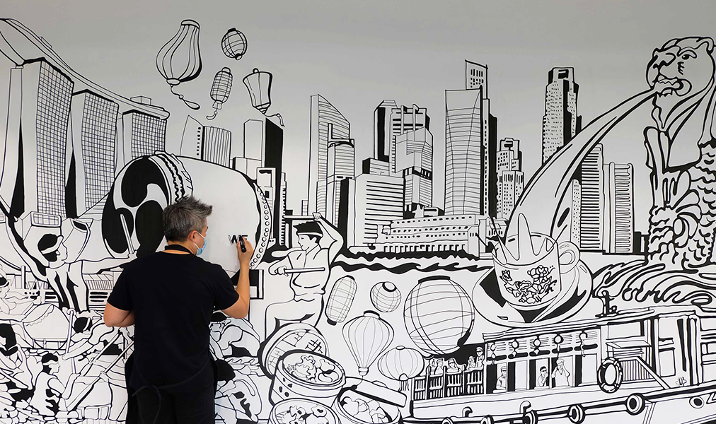 Ohm Chongthanatrakol working on mural in office of Chinese technology giant fit out by ISG