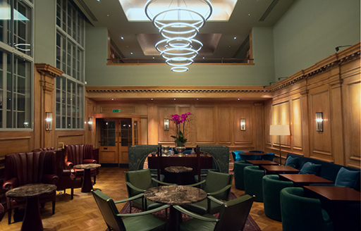 Ornate dining room with plush velvet chairs and wooden walls at 67 Pall Mall London fit out and restored by ISG Ltd