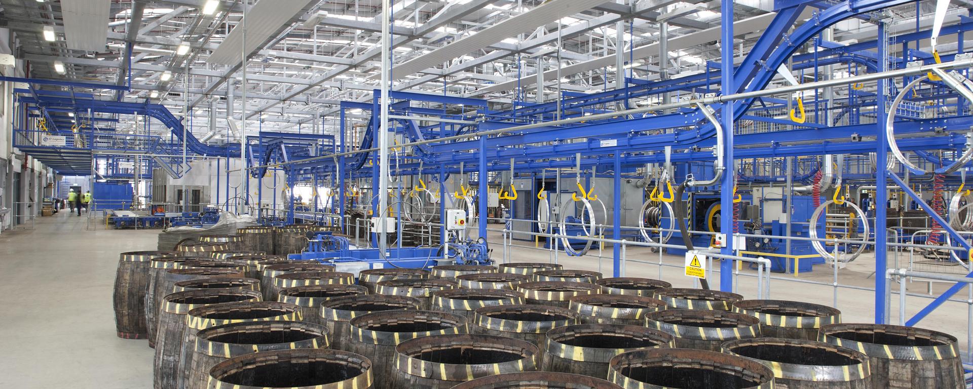 Whisky barrels being prepared in a warehouse
